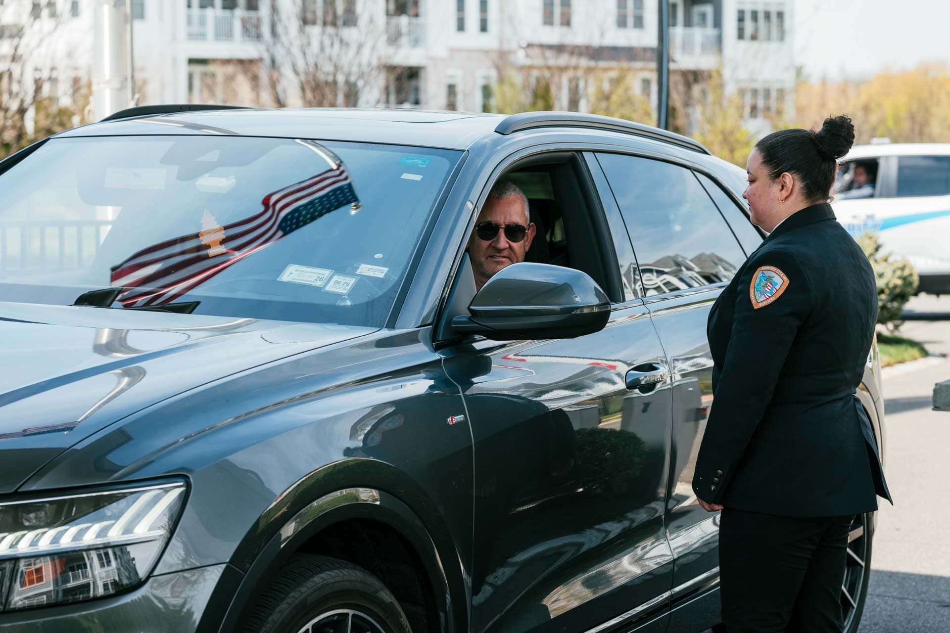 Security guard checking in visitors at a front gate entrance