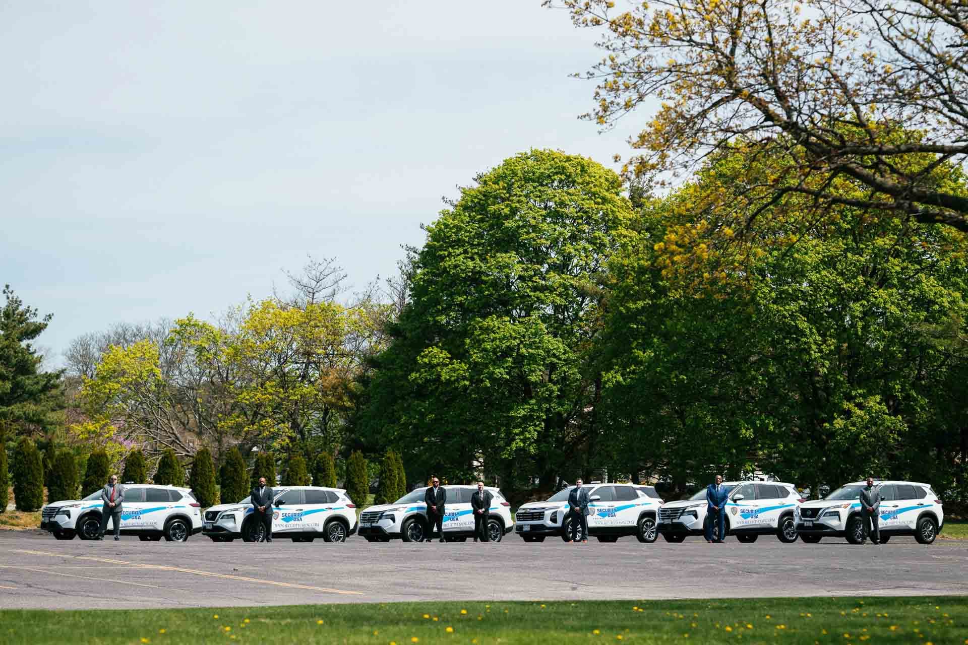 Image of Security USA® guards standing in front of security vehicles.